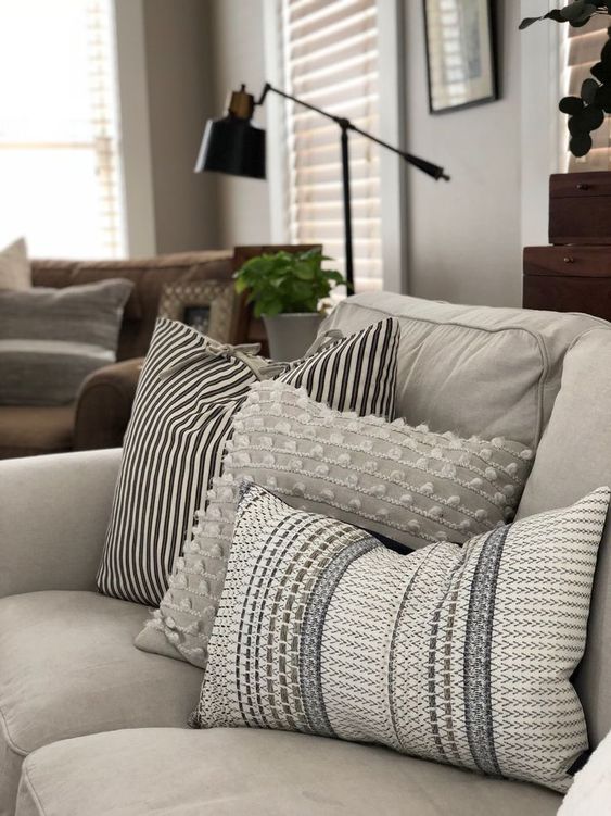 Farmhouse style throw pillows with rustic patterns, such as buffalo plaid and gingham checks