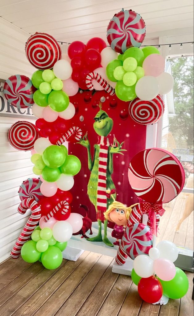 Children on a Grinchmas scavenger hunt, deciphering clues hidden among Grinch-themed decorations, searching for a Who-hash cookie recipe and festive treats
