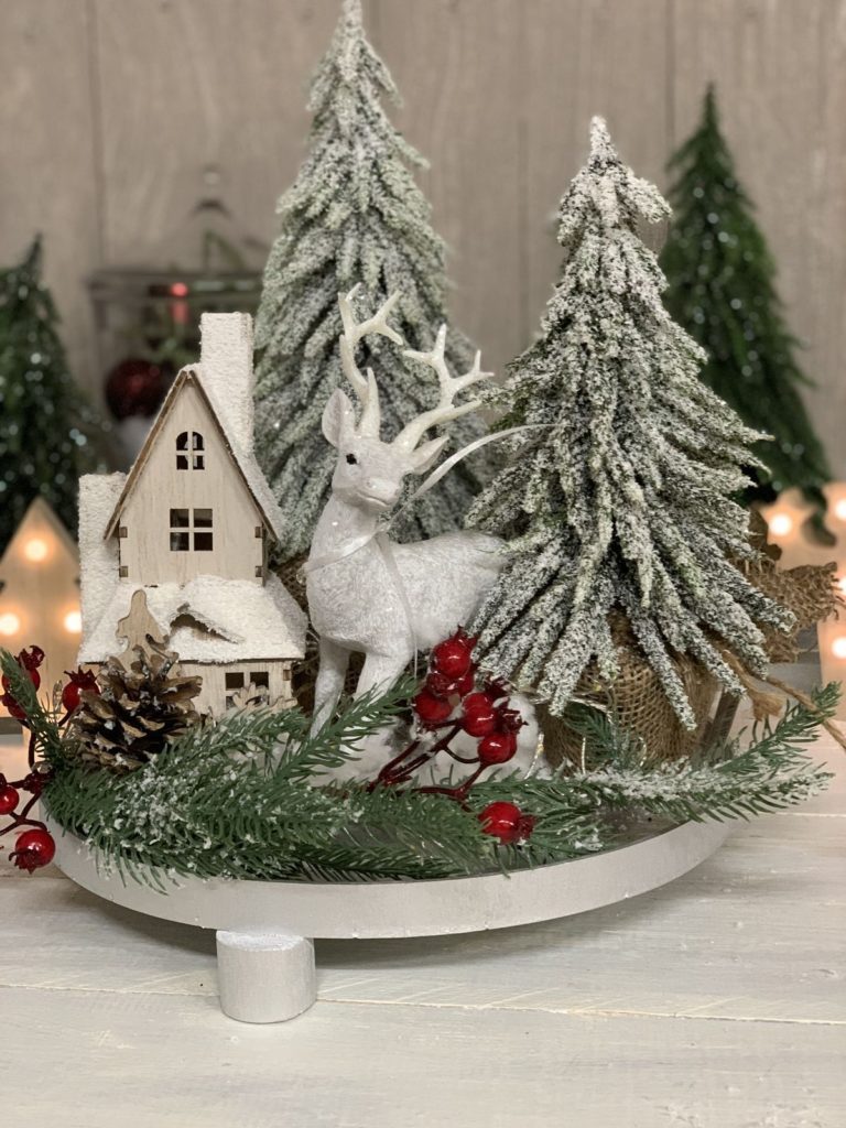 Christmas tree decorated with ornaments and lights placed on a kitchen countertop