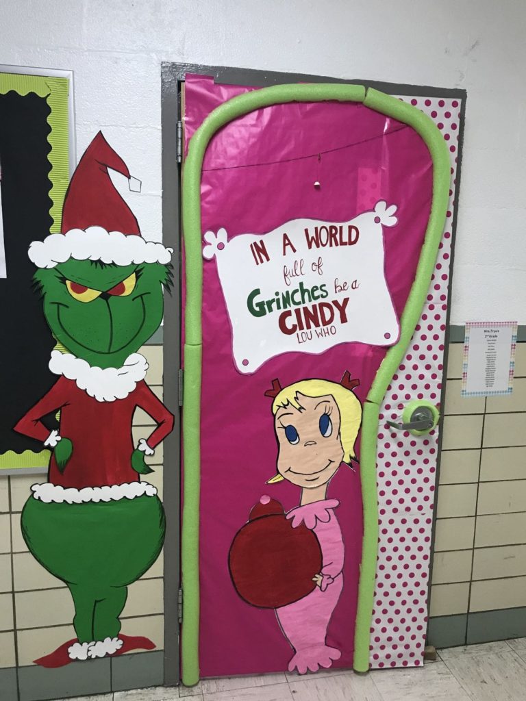 Grinch-themed Christmas photo booth with festive backdrop, silly props, and guests posing with Grinch-worthy expressions