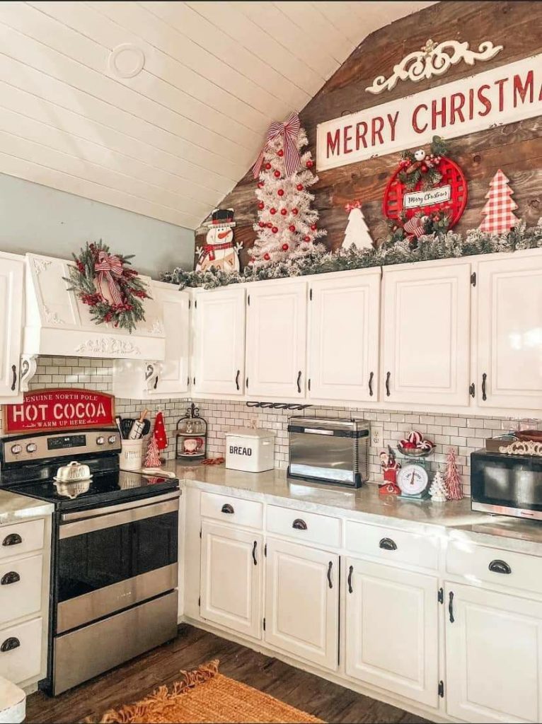 festive kitchen with a Christmas tree, wrapped gifts, and twinkling lights