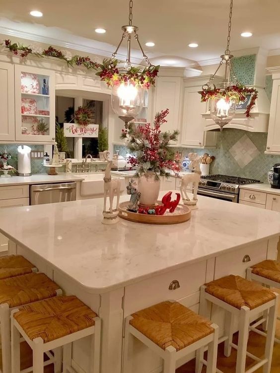 kitchen decorated in traditional Christmas colors, with red and green accents, gold ornaments, and a silver-toned garland.